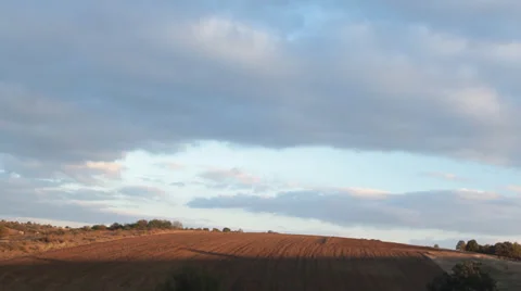 Sunset timelapse and moving clouds over the farm fields Stock Footage 31179103