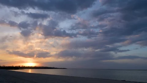 Sunset timelapse with blue colored clouds moving above a large lake.  Stock Footage 158453476