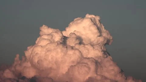 Sunset timelapse captures swelling foamy cumulus cloud - Dusk Sky and Warm Light Stock Footage 339643631