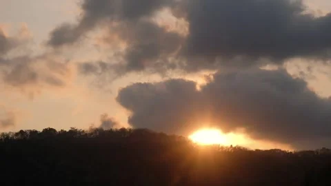 Sunset timelapse capturing the sun setting behind mountain silhouettes Stock Footage 348485968