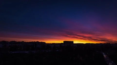 Sunset timelapse with colorful clouds moving above the crowded city buildings Stock Footage 75576016