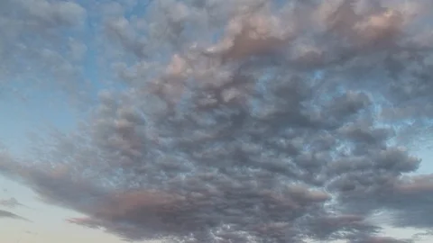 Sunset timelapse of the fast-moving clouds at sunset and blue hour Stock Footage 120284111