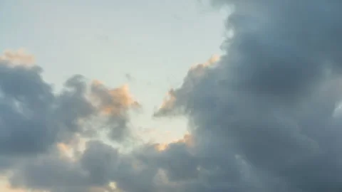 Sunset timelapse of fast moving clouds over sea with golden light and sky colors Stock Footage 313925914