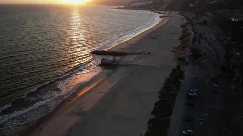 Sunset timelapse flyover of Will Rogers State Beach and PCH, California Stock Footage 336523032