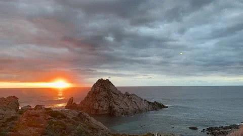 Sunset Timelapse: A Mesmerizing Oceanfront View with Majestic Rock Formation 動画素材 239829790