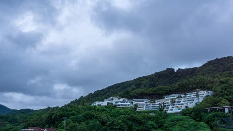 Sunset timelapse of modern villas on a hillside with epic dramatic clouds and Stock Footage 320164093