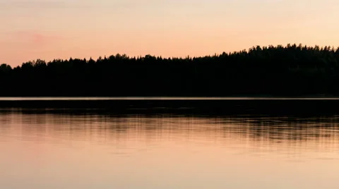 Sunset timelapse of movement on calm water surface Stock Footage 54923527