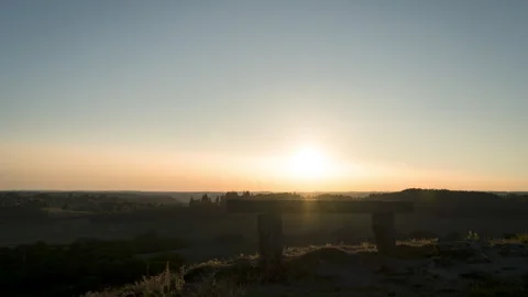 Sunset Timelapse with no clouds, orange sun, and bench, Corrèze Video stock 273619607
