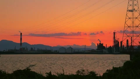 Sunset timelapse over the factory silhouette and river in Oita, Japan Stock Footage 336903509