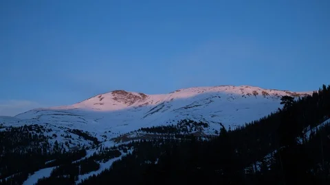 Sunset timelapse over snow peak and tree in rocky mountain, Colorado Stock Footage