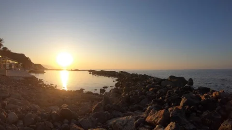 Sunset Timelapse, over water and rocky bay - Crete Stock Footage 117539317