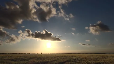 Sunset timelapse shows partly cloudy sky above flat plain - Clear Sky and Rays Stock Footage 339486332