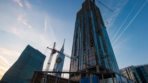 Sunset timelapse of skyscrapper construction works, pan Stock Footage