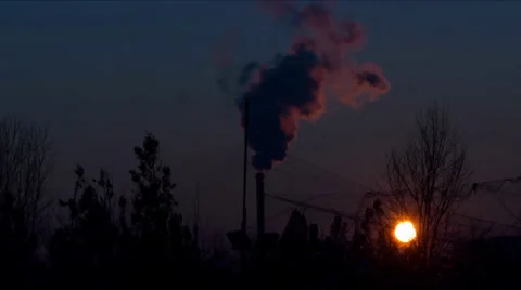 Sunset timelapse with a smoking pipe Stock Footage 26565534