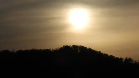Sunset timelapse with sun covered by clouds Stock Footage 89670792