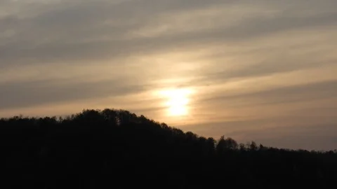 Sunset timelapse with sun covered by clouds 스톡 동영상 89670850