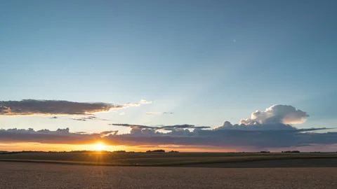 Sunset Timelapse sun day to blue sky hour over a wheat field Video stock 244979951