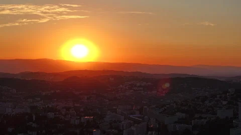 Sunset Timelapse With Sun Descending Toward Mountain Ridge Over City Stock Footage 346180169