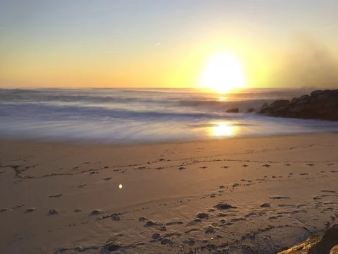 Sunset timelapse with waves crash on shore on a sandy beach Stock Footage 71632050