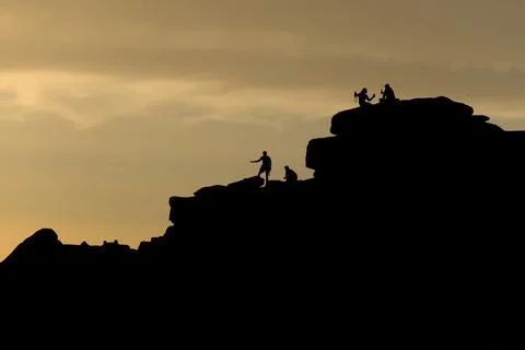 Sunset tourism at stanage edge, a couple take a selfie, climbers too Stock Photos