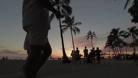Sunset tourists passing Stock Footage 231078056