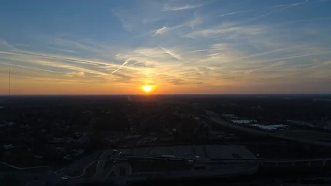 Sunset with traffic, buses, light rail, clouds &amp; contrails, orange &amp; blue sky Stock-Footage 97769688