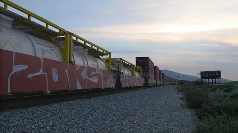 Sunset train roars past in Beaumont California Stock Footage 73816433