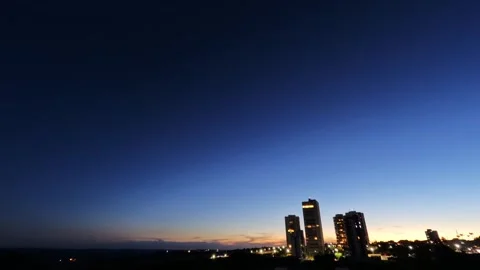 Sunset transitioning into night over an urban skyline Stock Footage 331046894