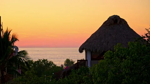 Sunset with trees and a house as foreground in 120fps in La Punta, Mexico Stock Footage 264755640