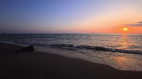 Sunset on a tropical island sandy beach with the sun reflected on the water  Stock Footage 332211286