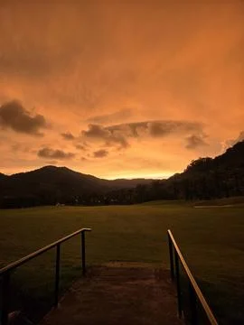 Sunset in the tropics with a bridge and clouds Stock Photos