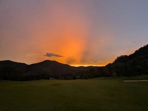 Sunset in the tropics with clouds and mount Stock Photos