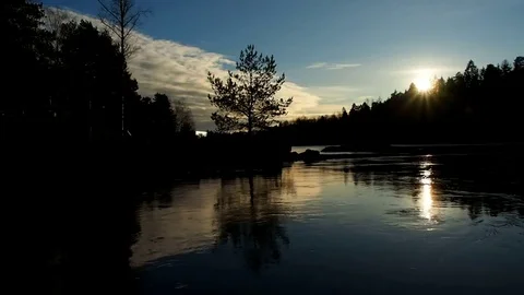 Sunset at twilight behind strong current in shimmering water in darkness Stock Footage 83252696
