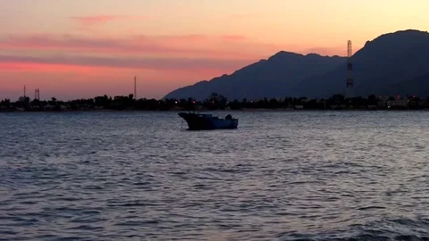 Sunset twilight floating boat on mild sea waves with audio Stock Footage