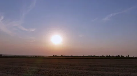 Sunset twilight rural field landscape 4k time-lapse video. Sun moving clear sky Stock Footage 68583521