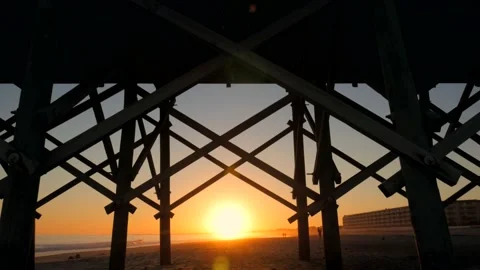 Sunset under a beach boardwalk Stock Footage 167372745