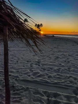 Sunset under a beach hut Stock Photos