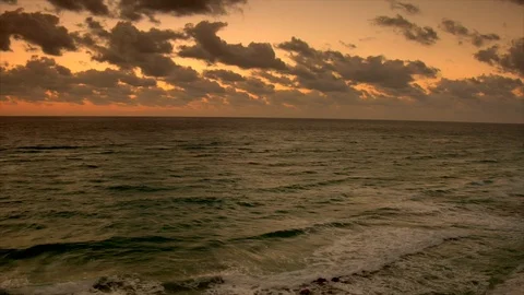 Sunset under horizon. Clouds and ocean waves view from beach. pan Stock Footage 102532282