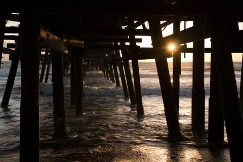 Sunset under pier Stock Photos