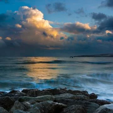 Sunset under storm clouds on the Dorset Coast Stock Photos