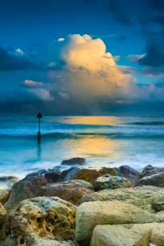 Sunset under storm clouds on the Dorset Coast Stock Photos