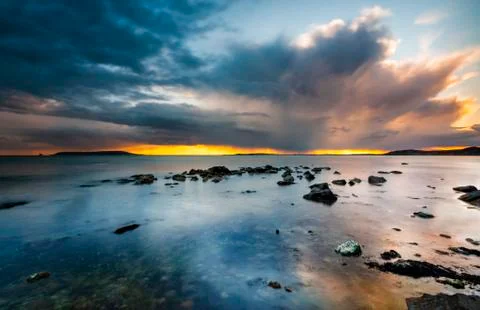 Sunset under storm clouds on the Dorset Coast Stock Photos
