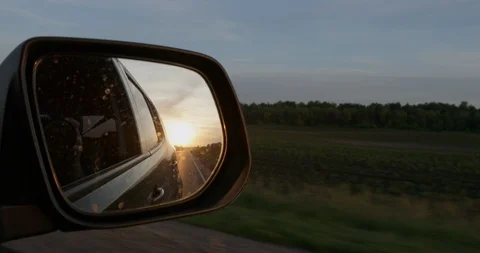 Sunset In valley In auto rear view mirror while driving Stock Footage 91497467