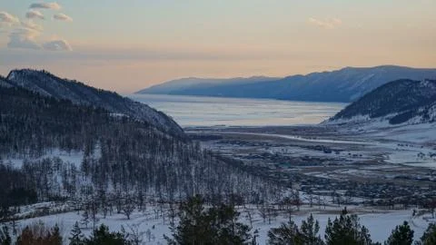 Sunset in the valley between the mountains with the village of Buguldeika on Stock Photos