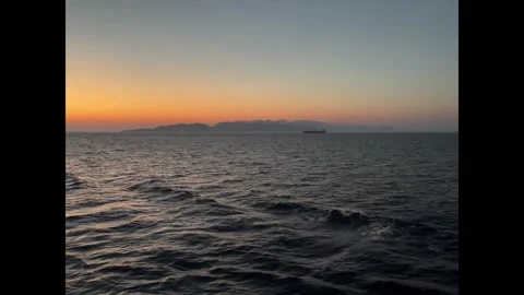 Sunset video from cruise ship off the coast of Greece with cargo ship 8-20-2 Stock Footage 343967441