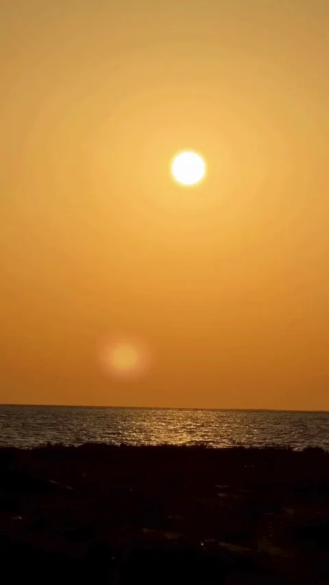 Sunset the video was filmed from inside a car driving along the beach Stock Footage 334697845