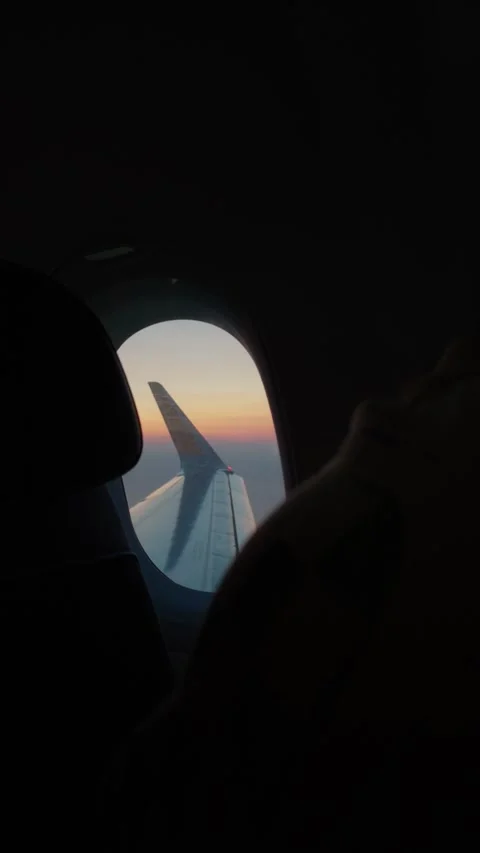 Sunset View from an Airplane Window: Capturing the Beauty of Late Afternoon Skie Stock Footage 335309970