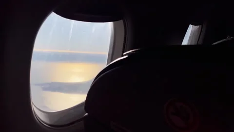 Sunset View From Airplane Window Over Coastal Ocean During In Flight Travel Video stock 328835156