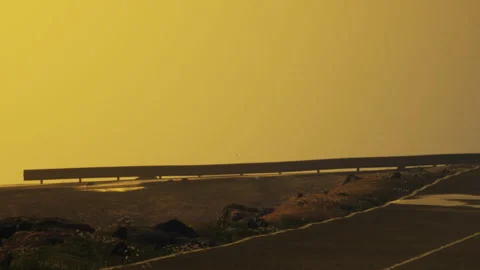 Sunset view along a road with yellow sky and distant horizon Stock Footage 340020783