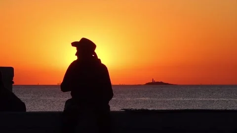 Sunset view and man with had enjoying ocean view Stock Footage 258595364